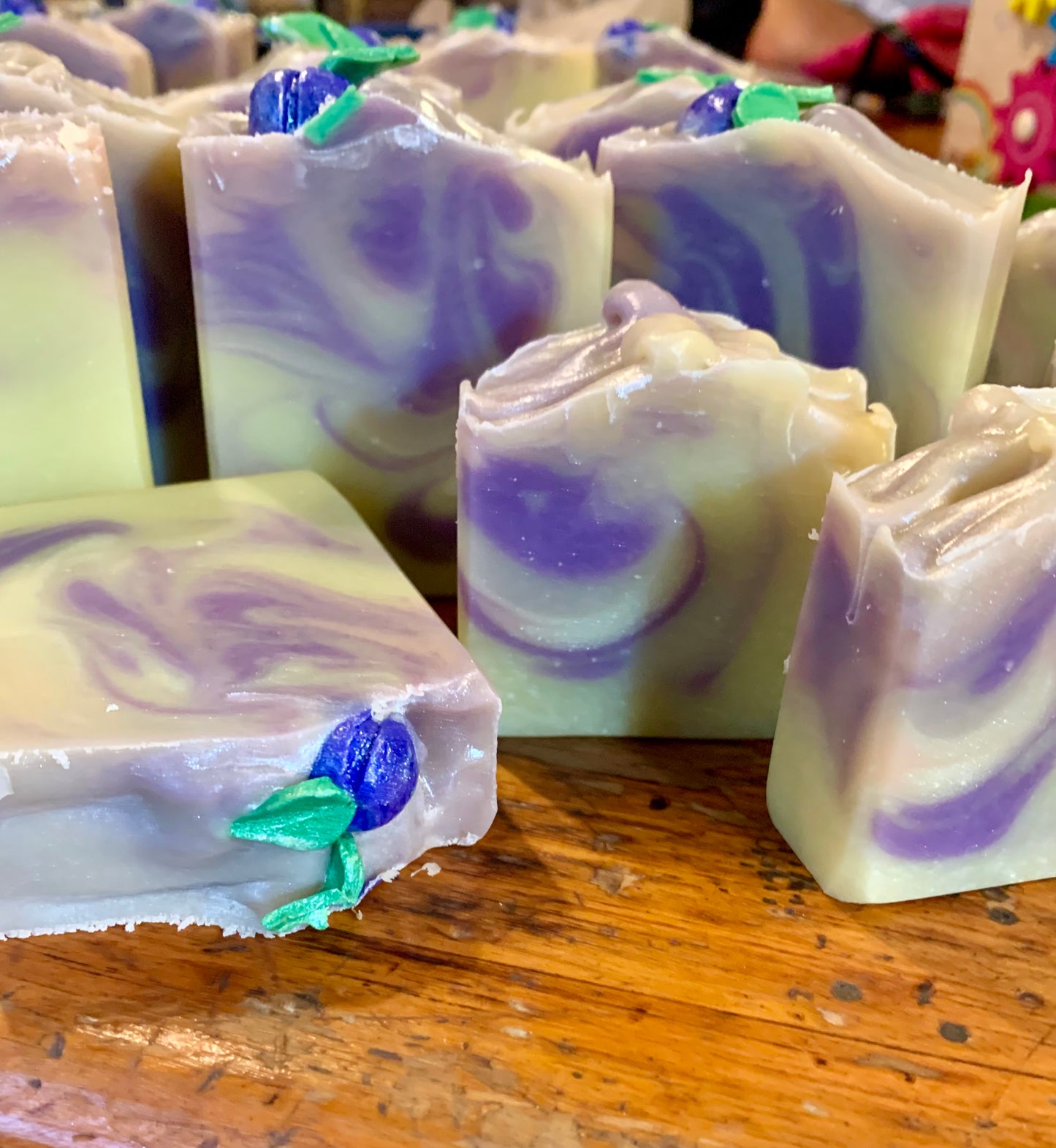 Handmade bars of soap in a cream color with purple and pink swirls