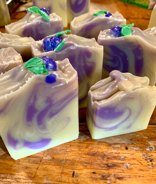 Handmade bars of soap with cream, purple and pink swirls